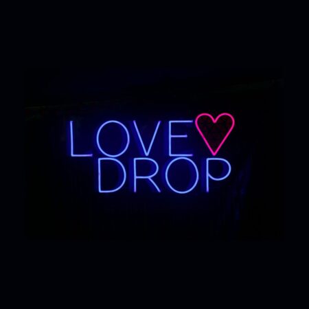 Neon sign reading “LOVE DROP” with a heart symbol.